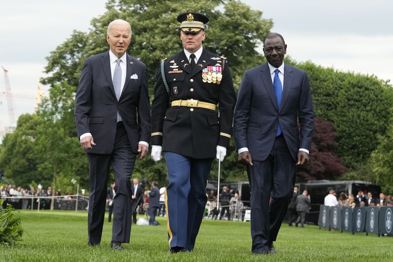 President Joe Biden, left, and Kenya's President William Ruto, right, review the troops with Col. David Rowland, commander of the 3rd U.S. Infantry Regiment, The Old Guard, during a State Arrival Ceremony on the South Lawn of the White House in Washington, Thursday, May 23. 2024. (AP Photo/Jacquelyn Martin)
