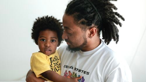 Atlanta rapper Deante' Hitchcock poses for a portrait with his son Otto, 1, at his home in Decatur on Monday, May 1, 2023.  (Natrice Miller/natrice.miller@ajc.com)