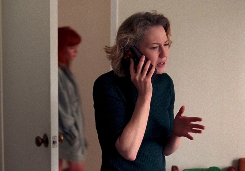 This image released by Netflix shows Natasha Lyonne, left, and Carrie Coon in a scene from "His Three Daughters." (Netflix via AP)