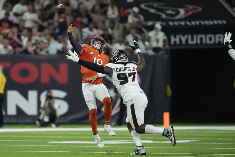 Chicago Bears quarterback Caleb Williams (18) throws over Houston Texans defensive tackle Mario Edwards Jr. (97) during the second half of an NFL football game Sunday, Sept. 15, 2024, in Houston. (AP Photo/Eric Christian Smith)