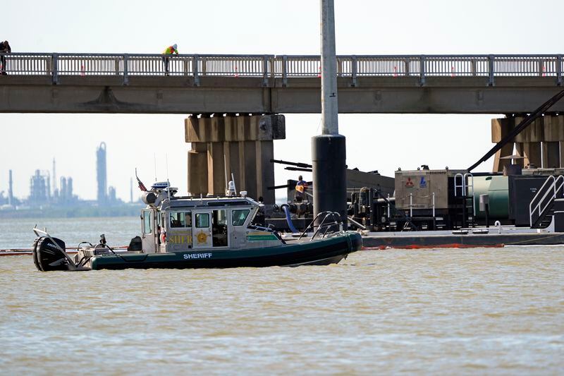 Officials patrol the waters at the site where a bardge crashed into the Pelican Island Bridge Wednesday, May 15, 2024, in Galvestobn, Texas. (AP Photo/David J. Phillip)