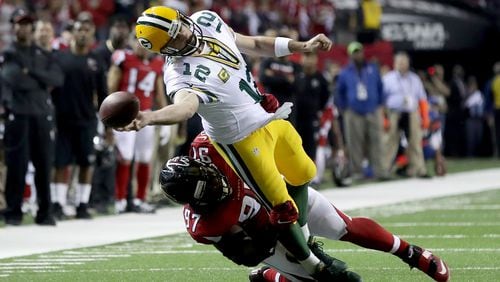 Grady Jarrett of the Falcons tries to pull down Packers QB Aaron Rodgers in the NFC Championship Game at the Georgia Dome.  (Photo by Rob Carr/Getty Images)