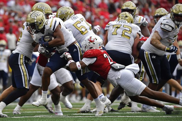 Louisville defensive back M.J. Griffin (26) attempts to bring down Georgia Tech running back Trelain Maddox (28) during the second half of an NCAA college football game in Louisville, Ky., Saturday, Sept. 21, 2024. (AP Photo/Timothy D. Easley)