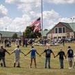 
                        Mourners hold arms in a ring around a makeshift memorial at Apalachee High School in Winder, Ga., on Saturday, Sept. 7, 2024. As residents in Winder, Ga., consoled one another, questions rose about whether more could have been done to prevent the attack in which a gunman killed two students and two teachers last week at Apalachee High School. (Christian Monterrosa/The New York Times)
                      