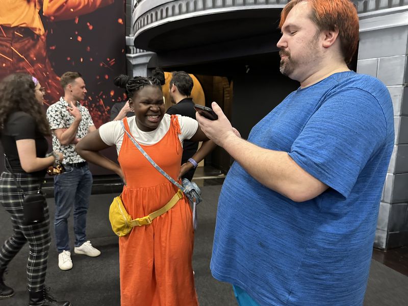 "Survivor" season 42 winner Maryanne Oketch came from Canada for the party and meets fan Northie Stangl. RODNEY HO/rho@ajc.com