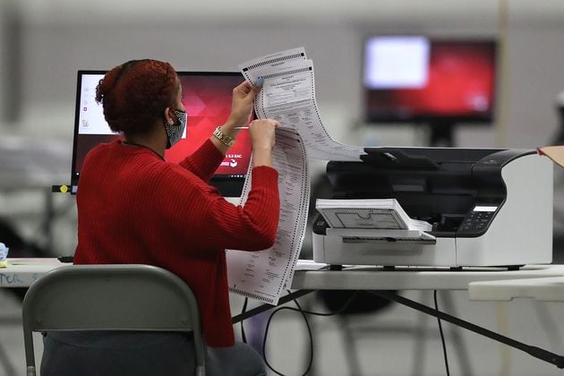 DeKalb County election workers scan ballots to recount more votes in the 2020 presidential election. Curtis Compton / Curtis.Compton@ajc.com