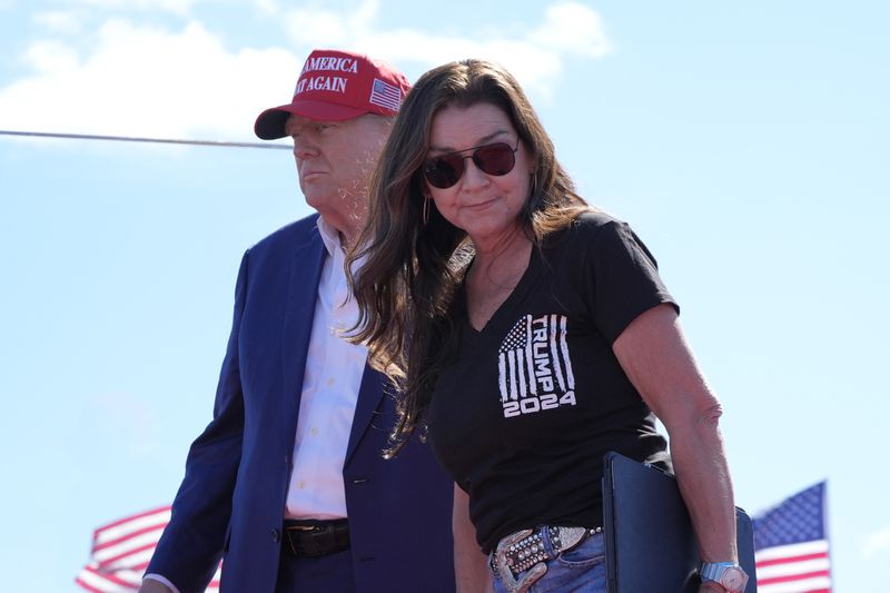 Gretchen Wilson walks off stage after speaking at a campaign event for Republican presidential nominee former President Donald Trump, seen at left, at Central Wisconsin Airport, Saturday, Sept. 7, 2024, in Mosinee, Wis. (AP Photo/Alex Brandon)