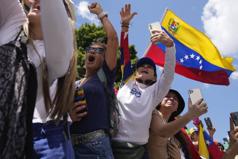 People cheer for opposition leader Maria Corina Machado during a rally to protest official results that declared President Nicolas Maduro the winner of the July presidential election, in Caracas, Venezuela, Saturday, Aug. 17, 2024. (AP Photo/Ariana Cubillos)