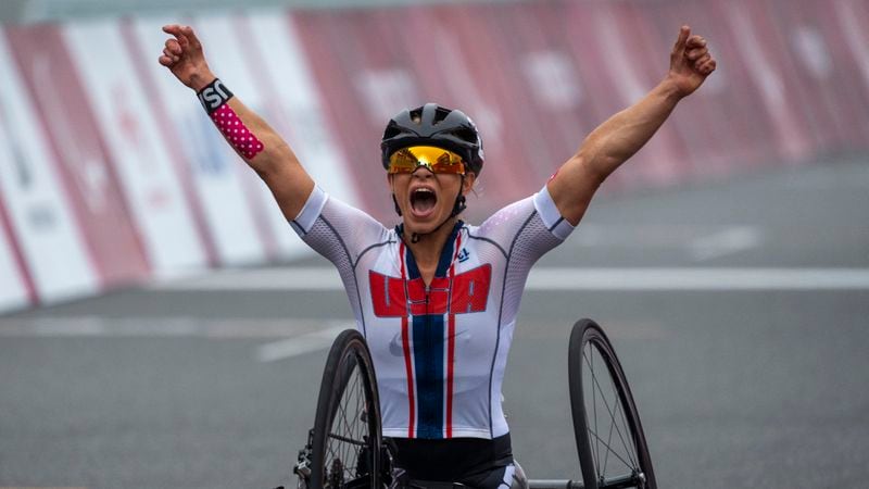 FILE - Oksana Masters, of the United States, celebrates after winning at Women's H5 Road Race at the Fuji International Speedway at the Tokyo 2020 Paralympic Games, Sept. 1, 2021, in Tokyo, Japan. Paralympians are not participating. They are competing. A number of athletes preparing for the Paris 2024 Paralympic Games proclaimed that message on their social feeds over the past few days, reminding the world that Olympians are not the only athletes coming to Paris looking for gold. (AP Photo/Emilio Morenatti, File)