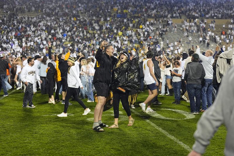 Colorado fans celebrate after the team's overtime victory over Baylor in an NCAA college football game Saturday, Sept. 21, 2024, in Boulder, Colo. (AP Photo/David Zalubowski)