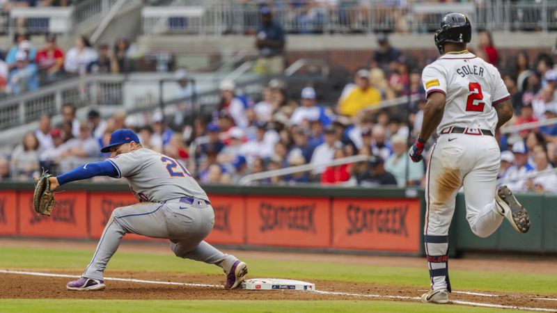 New York Mets first baseman Pete Alonso, left, catches the ball before Atlanta Braves' Jorge Soler, right, can reach first in the fourth inning of the second baseball game of a doubleheader, Sept. 30, 2024, in Atlanta. (AP Photo/Jason Allen)