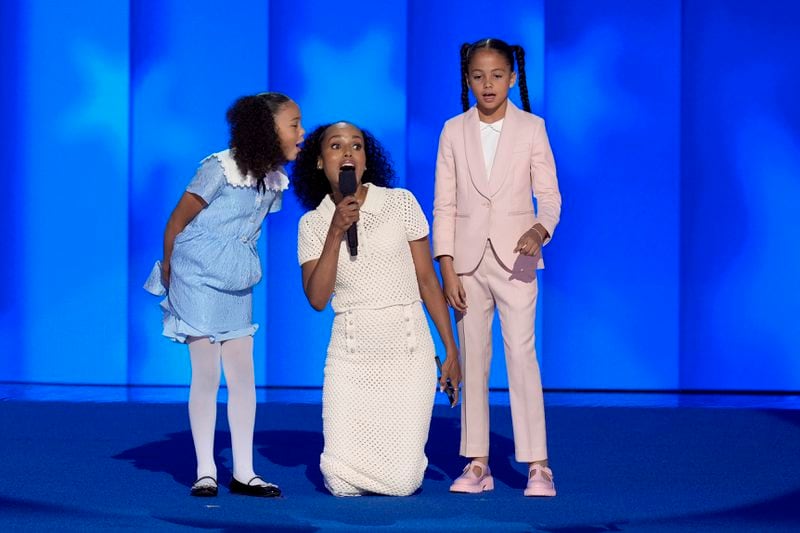 Kerry Washington, center, with grand-nieces of Vice President Kamala Harris Amara Ajagu, right, and Leela Ajagu, speak during the Democratic National Convention Thursday, Aug. 22, 2024, in Chicago. (AP Photo/J. Scott Applewhite)