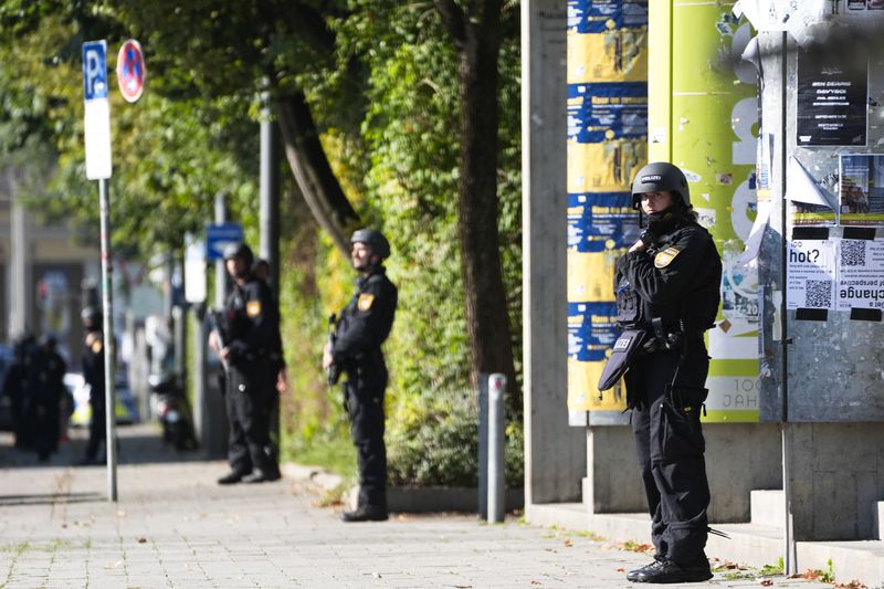 Police officers patrol after police fired shots at a suspicious person near the Israeli Consulate and a museum on the city's Nazi-era history in Munich, Germany, Thursday, Sept. 5, 2024. (AP Photo/Matthias Schrader)