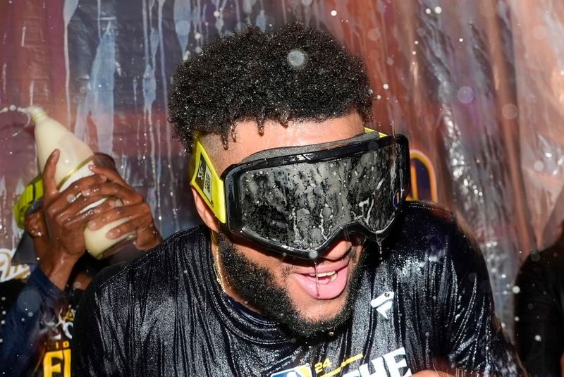 Milwaukee Brewers' Jackson Chourio is douced after a baseball game against the Philadelphia Phillies Wednesday, Sept. 18, 2024, in Milwaukee. The Brewers won 2-1 and clinched the National League Central division. (AP Photo/Morry Gash)