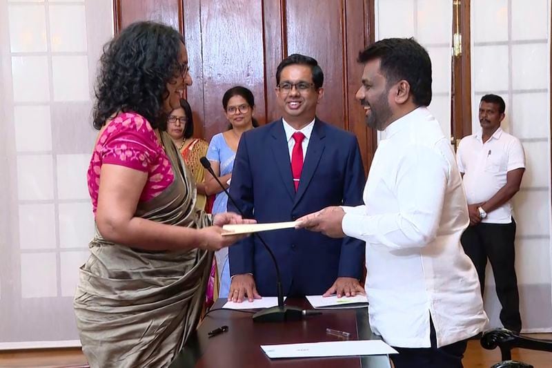 National People's power lawmaker Harini Amarasuriya, 54, left, takes oath for the post of Sri Lanka's Prime Minister in front of President Anura Kumara Dissanayake, in Colombo, Sri Lanka, Monday, Sept. 23, 2024. (Sri Lanka Government Information Department via AP)