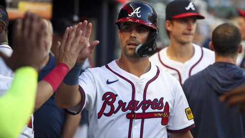 Atlanta Braves second baseman Whit Merrifield celebrates scoring a run with teammates in the dugout during the third inning against the Philadelphia Phillies at Truist Park, Thursday, August 22, 2024, in Atlanta.(Jason Getz / AJC)
