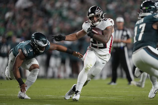 Atlanta Falcons running back Tyler Allgeier (25) runs with the ball near Philadelphia Eagles linebacker Nolan Smith Jr. (3) during the second half of an NFL football game Monday, Sept. 16, 2024, in Philadelphia. (AP Photo/Matt Rourke)