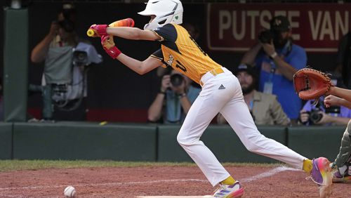 Lake Mary, Fla.'s Hunter Alexander lays down a walk-off bunt, driving in the game-winning run in the eighth inning of the Little League World Series Championship game against Taiwan in South Williamsport, Pa., Sunday, Aug. 25, 2024. Florida won in eight innings 2-1. (AP Photo/Gene J. Puskar)