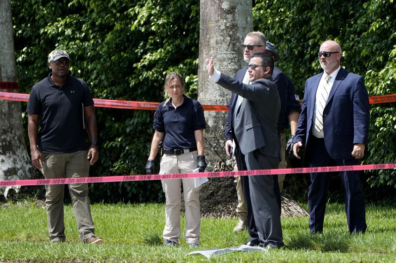 Law enforcement officials work outside of the Trump International Golf Club after the apparent assassination attempt of Republican presidential nominee and former President Donald Trump Monday, Sept. 16, 2024, in West Palm Beach, Fla. (AP Photo/Lynne Sladky)