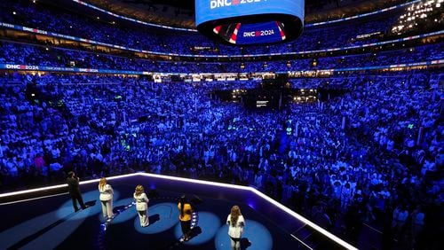 Rep. Lucy McBath, D-Ga., stands onstage and is joined by Abbey Clements of Newton, Conn., Kim Rubio of Uvalde, Texas, Melody McFadden of Charleston, S.C.,, and Edgar Vilchez of Chicago, during the final day of the Democratic National Convention in Chicago, Thursday, Aug. 22, 2024. (Mike Segar/Pool via AP)