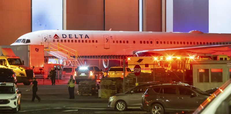 Multiple Atlanta Fire Rescue Department units and police park outside a Delta Maintenance facility near Hartsfield-Jackson International Airport early Tuesday, Aug. 27, 2024 in Atlanta. (John Spink/Atlanta Journal-Constitution via AP)