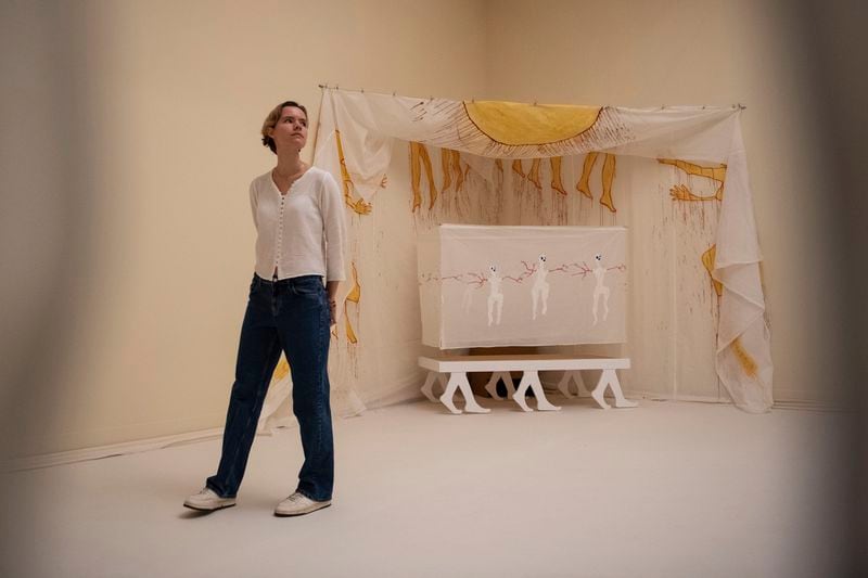 A woman passes by an artwork by Delaine Le Bas during the Turner Prize 2024 press preview at Tate Britain in London, part of the 40th anniversary exhibition featuring four shortlisted artists, Tuesday, Sept. 24, 2024. (AP Photo/Thomas Krych)