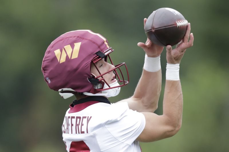 FILE - Washington Commanders wide receiver Luke McCaffrey catches a pass during an NFL football practice at the team's training facility in Ashburn, Va., on July 24, 2024. Luke McCaffrey this weekend will become the latest member of his family to play in the NFL. (AP Photo/Luis M. Alvarez, File)