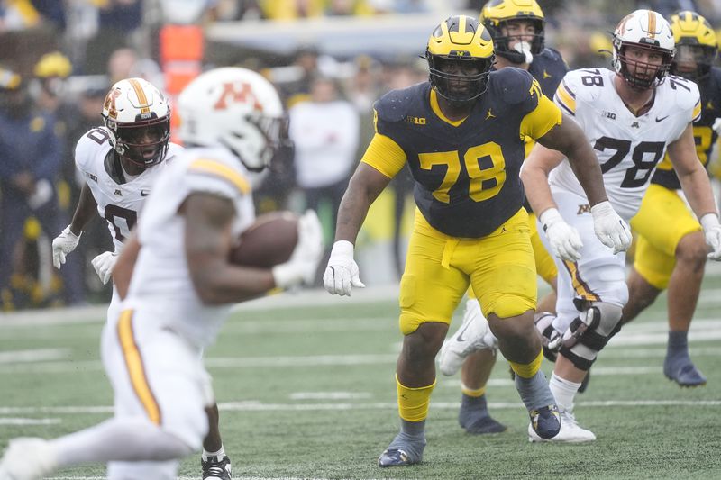 Michigan defensive lineman Kenneth Grant (78) chases Minnesota running back Darius Taylor during the first half of an NCAA college football game, Saturday, Sept. 28, 2024, in Ann Arbor, Mich. (AP Photo/Carlos Osorio)