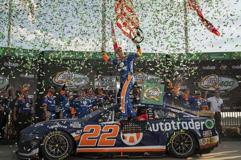 Joey Logano, center, celebrates after winning a NASCAR Cup Series auto race at Atlanta Motor Speedway, Sunday, September 8, 2024, in Hampton, Ga. (Hyosub Shin/Atlanta Journal-Constitution via AP)