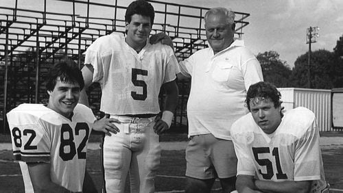 Legendary Georgia placekicker Kevin Butler (No. 5) poses with holder Jimmy Harrell (82), snapper Paul Messer (51) and and longtime UGA kicking coach Bill Hartman. The three players combined to make a 60-yard, game-winning field goal against Clemson in 1984. That kick remains the longest in school history. (Photo provided by UGA Athletics)