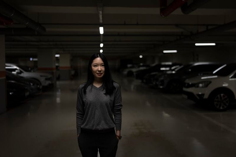 Shin Nari, a 34-year-old graduate student who says she is worried about nuclear war, stands for a portrait in an underground parking lot that also serves as a bomb shelter in Seoul, Tuesday, May 28, 2024. (AP Photo/Jae C. Hong)