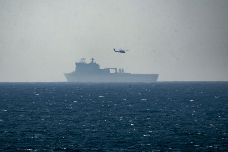 A ship is seen off the coast of Gaza near a U.S.-built floating pier, not seen, that is used to facilitate aid deliveries, as seen from the central Gaza Strip, Wednesday, July 10, 2024. (AP Photo/Abdel Kareem Hana)