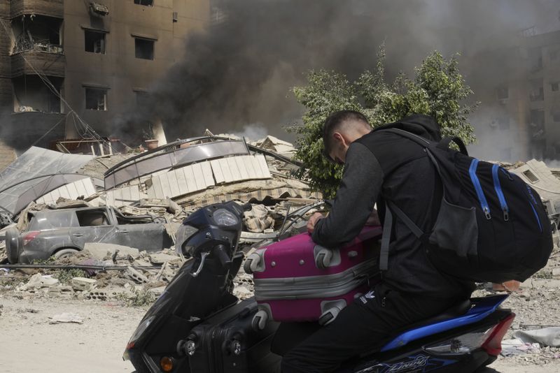 Smoke rises from Israeli airstrikes in Beirut's southern suburbs, Saturday, Sept. 28, 2024. (AP Photo/Hussein Malla)