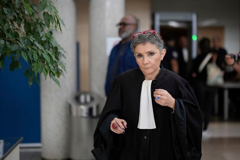 Lawyer Beatrice Zavarro walks during the trial of her client, defendant Dominique Pelicot, in the Avignon court house, southern France, Thursday, Sept. 5, 2024. A woman who was allegedly drugged by her now ex-husband so that she could be raped while unconscious by other men is testifying in a court in France about her yearslong ordeal. (AP Photo/Lewis Joly)