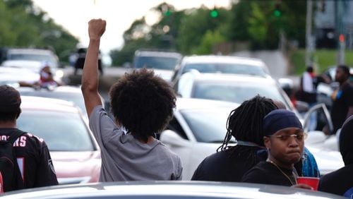 Protesters gather on University Avenue on Wednesday near the burned Wendy’s in southwest Atlanta.