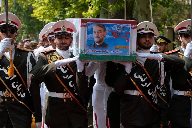 Army members carry the flag-draped coffin of Iranian Foreign Minister Hossein Amirabdollahian, who was killed in a helicopter crash along with President Ebrahim Raisi on Sunday in a mountainous region of the country's northwest, during a funeral ceremony at the foreign ministry in Tehran, Iran, Thursday, May 23, 2024. The death of Raisi, Foreign Minister Hossein Amirabdollahian and six others in the crash on Sunday comes at a politically sensitive moment for Iran, both at home and abroad.(AP Photo/Vahid Salemi)