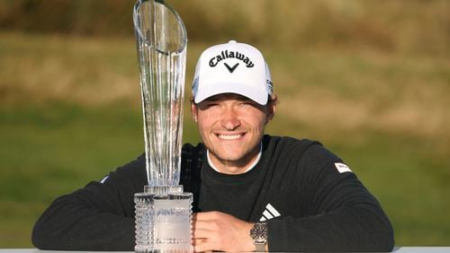 Denmark's Rasmus Hojgaard poses with the trophy after winning the Amgen Irish Open 2024 at Royal County Down in Newcastle, County Down, England, Sunday Sept. 15, 2024. (Peter Morrison/PA via AP)