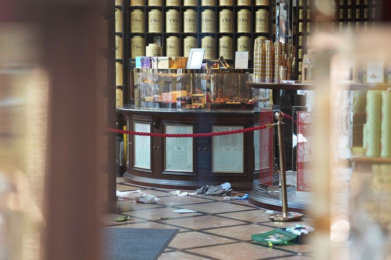 Discarded clothing and emergency medical equipment is seen inside the TWG Tea shop in Leicester Square, London, as a man has been arrested after an 11-year-old girl and 34-year-old woman were stabbed, in London, Monday, Aug. 12, 2024. (James Manning/PA via AP)