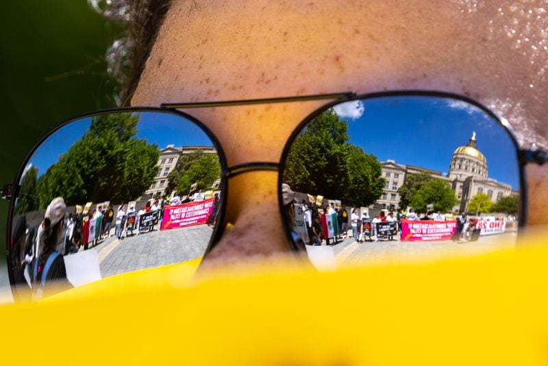 Immigrant rights activists protest HB 1105, which would would mandate that local law enforcement work more closely with ICE, at Liberty Plaza in front of the Capitol in Atlanta on Wednesday, May 1, 2024. (Arvin Temkar / AJC)