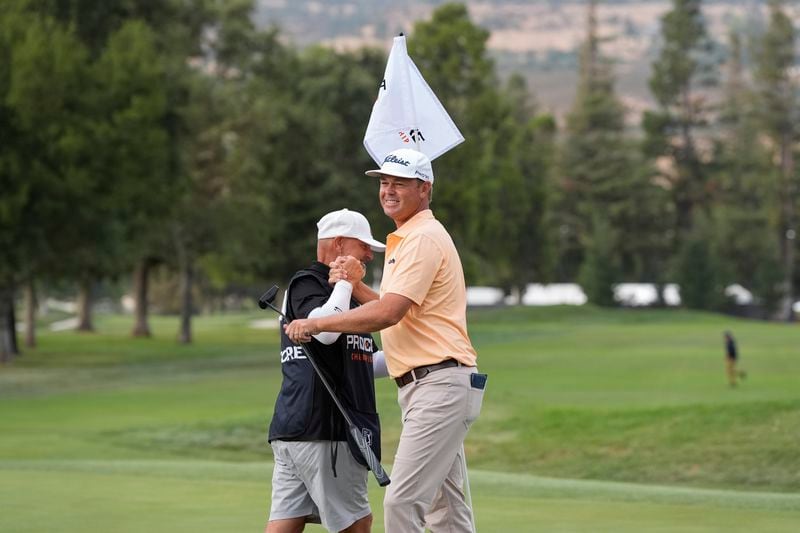 Patton Kizzire, right, celebrates with his caddie after winning the Procore Championship golf tournament at Silverado Resort North Course, Sunday, Sept. 15, 2024, in Napa, Calif. (AP Photo/Godofredo A. Vásquez)