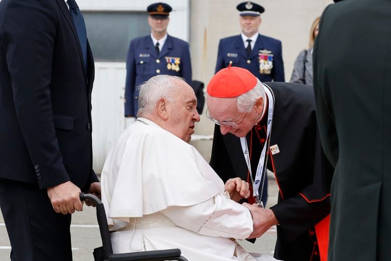 Pope Francis is greeted by Cardinal Jozef De Kesel during the farewell ceremony at Melsbroek Air Base at the end of a four-day visit to Belgium and Luxembourg, Sunday, Sept. 29, 2024. (AP Photo/Geert Vanden Wijngaert)