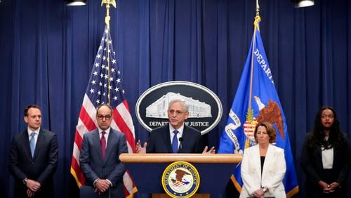 Attorney General Merrick Garland, center, speaks with reporters about an antitrust lawsuit against real estate software company RealPage during a news conference at the Department of Justice, Friday, Aug. 23, 2024, in Washington. (AP Photo/Mark Schiefelbein)