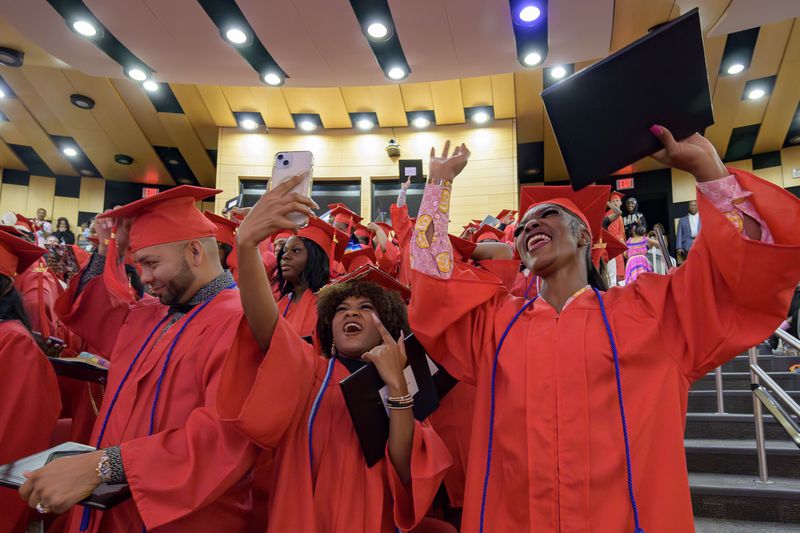 Keywanda Ashley, right, and Naomy Seiry Arzu Cruz, and Darwin Argueta, left, celebrate after receive their high school equivalency (HiSET) diplomas during a graduation ceremony for the Youth Empowerment Project (YEP) which received money from the NBA Foundation program in New Orleans, Thursday, June 27, 2024. (AP Photo/Matthew Hinton)