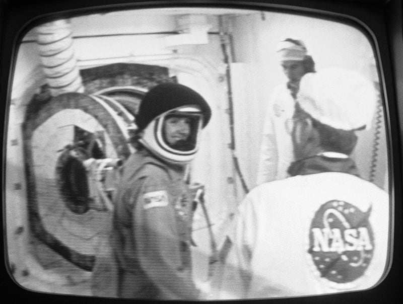 FILE - Teacher Christa McAuliffe smiles after she was suited up for her space flight at the Kennedy Space Center, Florida, Jan. 27, 1986. (NASA via AP, File)