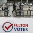 Fulton County elections workers open and sort ballots on Jan. 5, 2021, at the Georgia World Congress Center in Atlanta. (John Spink/The Atlanta Journal-Constitution)