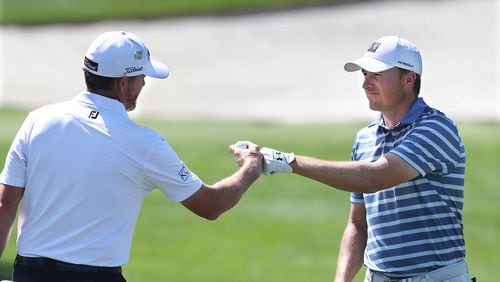 Monday at Augusta National: A day after winning the Valero Texas Open, Jordan Spieth (right) gets a fist bump from Jimmy Walker as he arrives to get in some work for the Masters, which begins Thursday in Augusta.