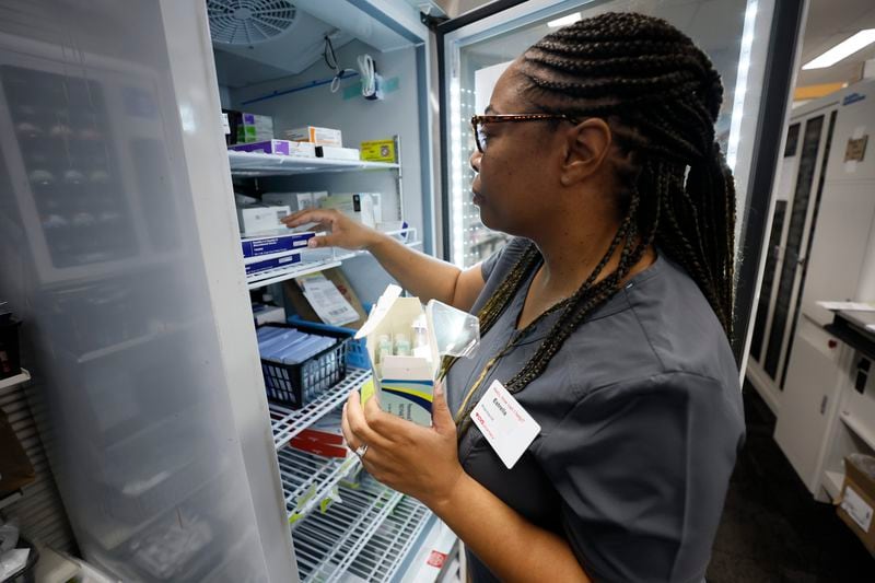 Pharmacist Estrella Clemons at CVS pulls vaccines from a fridge ready to be administrated to a person at the North Decatur Store on Wednesday, Sept. 13. 2023. On Monday, the Food and Drug Administration approved the revised vaccines, anticipating their arrival shortly after a surge in COVID cases during the summer and just before the onset of flu season.
Miguel Martinez /miguel.martinezjimenez@ajc.com