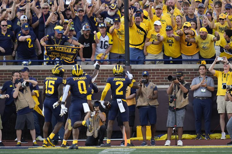 Michigan defensive back Will Johnson (2) celebrates his 42-yard interception for a touchdown against Southern California in the second half of an NCAA college football game in Ann Arbor, Mich., Saturday, Sept. 21, 2024. (AP Photo/Paul Sancya)