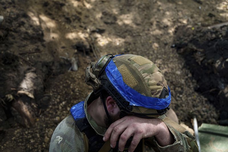 A Ukrainian national guard serviceman of Khartia brigade prepares to reload his D-20 cannon while firing towards Russian positions on the front line near Kharkiv, Ukraine, Monday, June 10, 2024. (AP Photo/Evgeniy Maloletka)