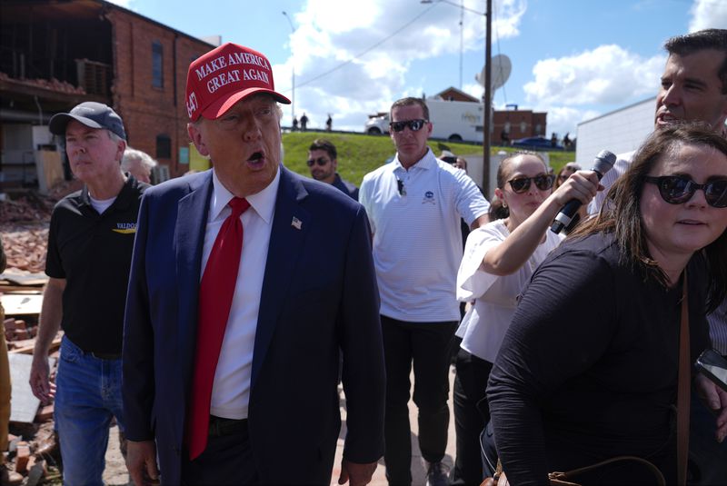 Republican presidential nominee former President Donald Trump walks outside the Chez What furniture store as he visits Valdosta, Ga., a town impacted by Hurricane Helene, Monday, Sept. 30, 2024. (AP Photo/Evan Vucci)